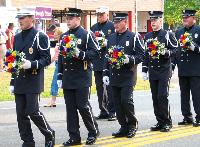 Firefighters march solemnly during the Fireman's Parade-Carnival.