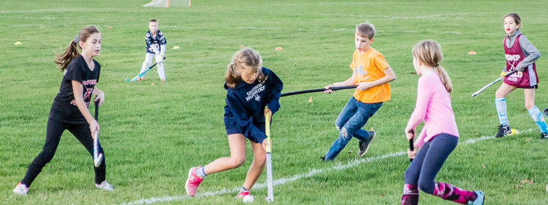 children playing field hockey