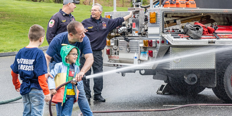 kids and fireman with firehose