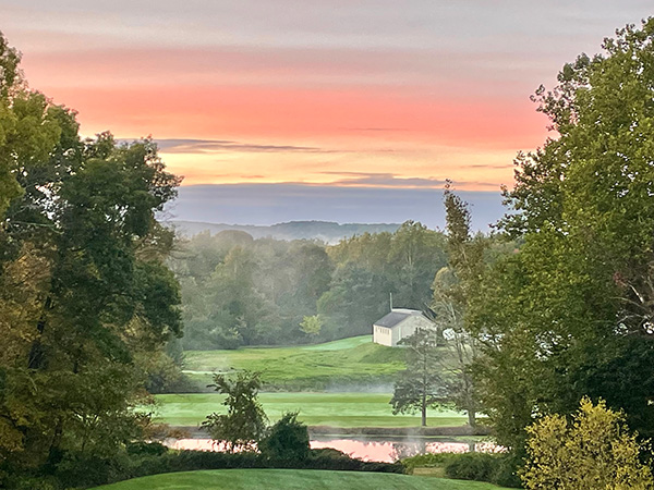 sunset over a house in a valley