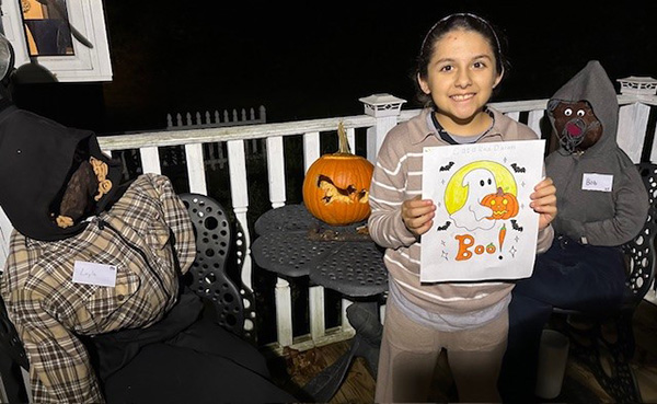 child with scarecrows