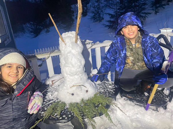 picture of an upside down snowman and two smiling children