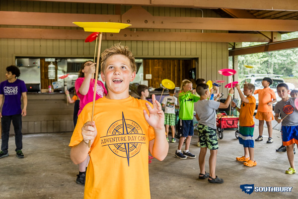campers spinning plates on sticks